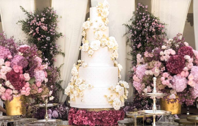 Luxury white tiered wedding cake with cascading white sugar roses and gold leaf at Villa Collazzi near Florence, Tuscany, Italy., Tuscan Wedding Cakes