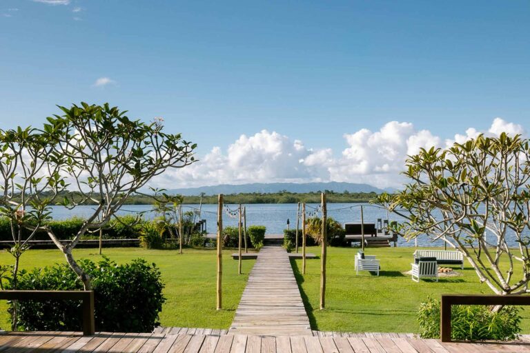 Garden lawn and boardwalk leading to Placencia Lagoon, Umaya Resort and Adventures