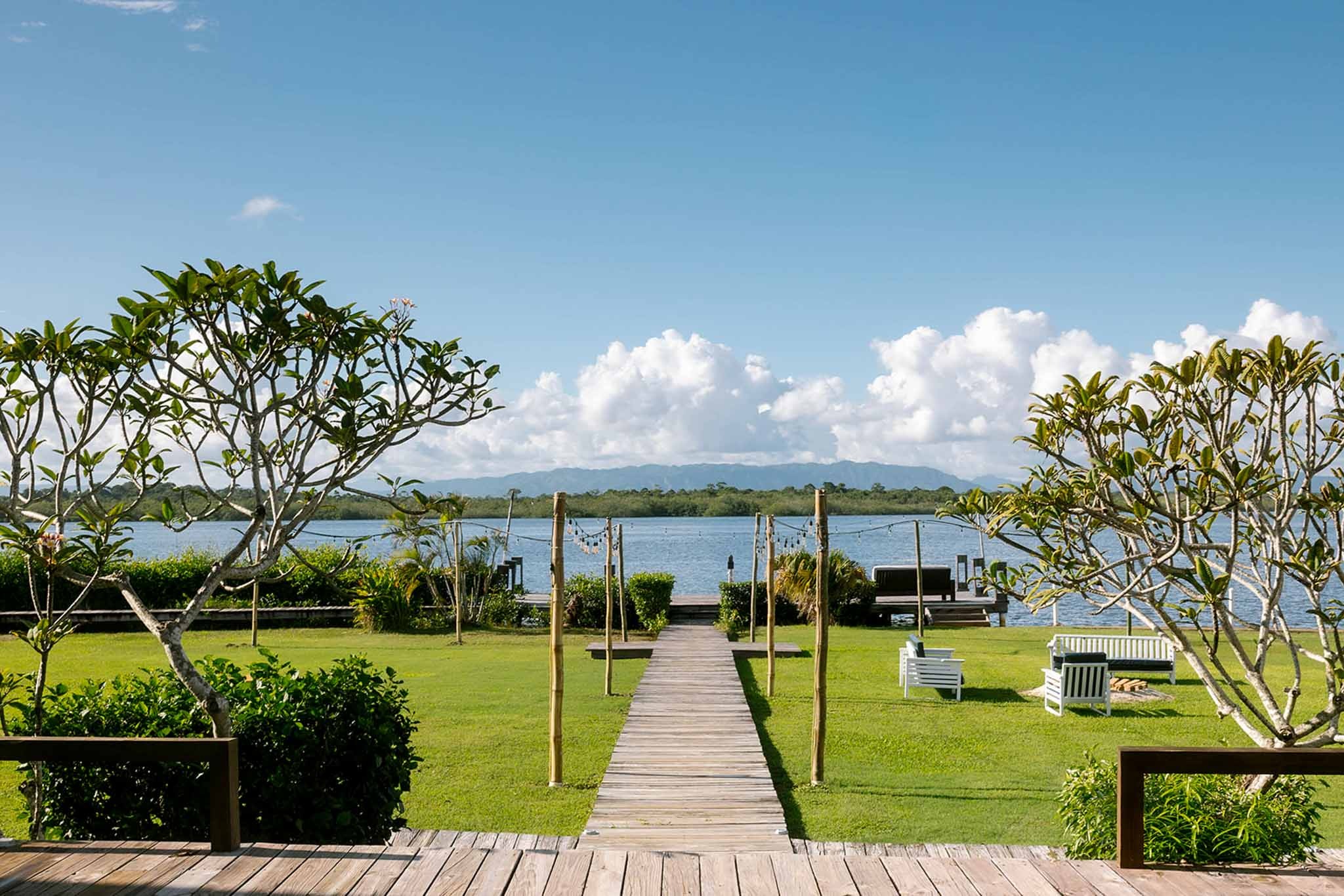 Garden lawn and boardwalk leading to Placencia Lagoon, Umaya Resort and Adventures