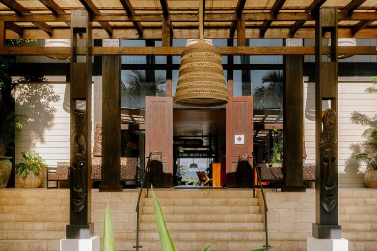Restaurant entrance with carved timber columns, Umaya Resort and Adventures