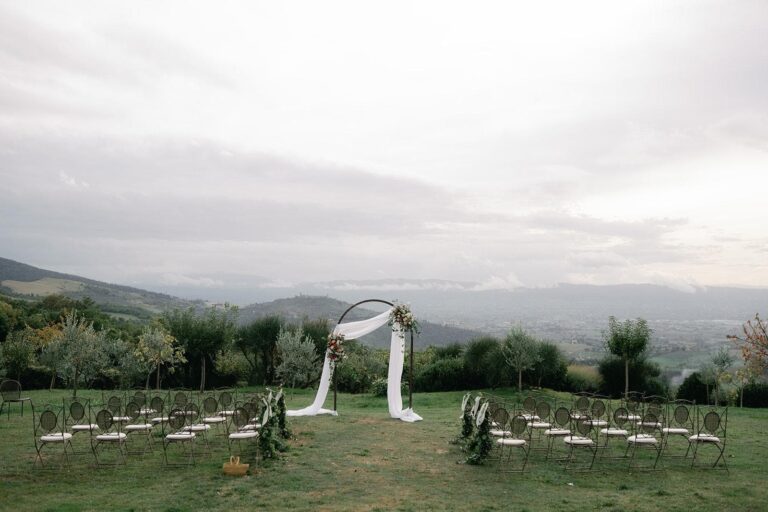 A ceremony arch on the ridge, the chairs facing the valley, Umbria Weddings and Events