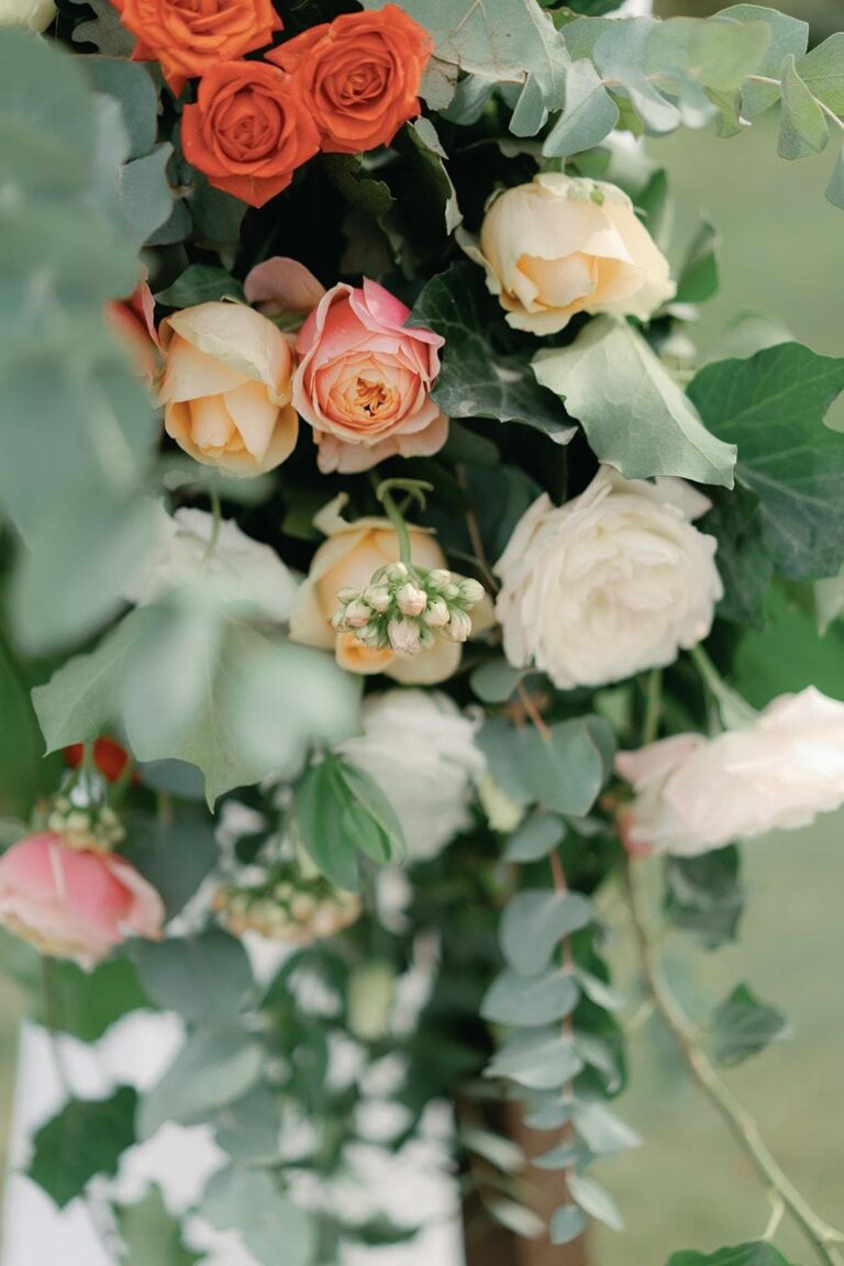 Roses, ranunculus and eucalyptus on the ceremony arch, Umbria Weddings and Events