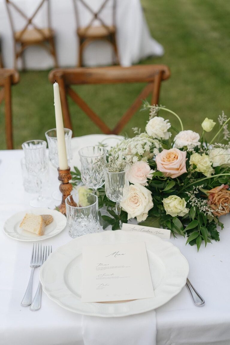 A place setting on the lawn: menu card, taper, garden roses, Umbria Weddings and Events