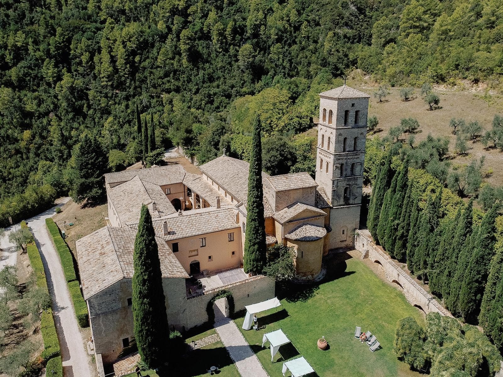 Abbazia di San Pietro in Valle from the air, cypresses along the drive, Umbria Weddings and Events