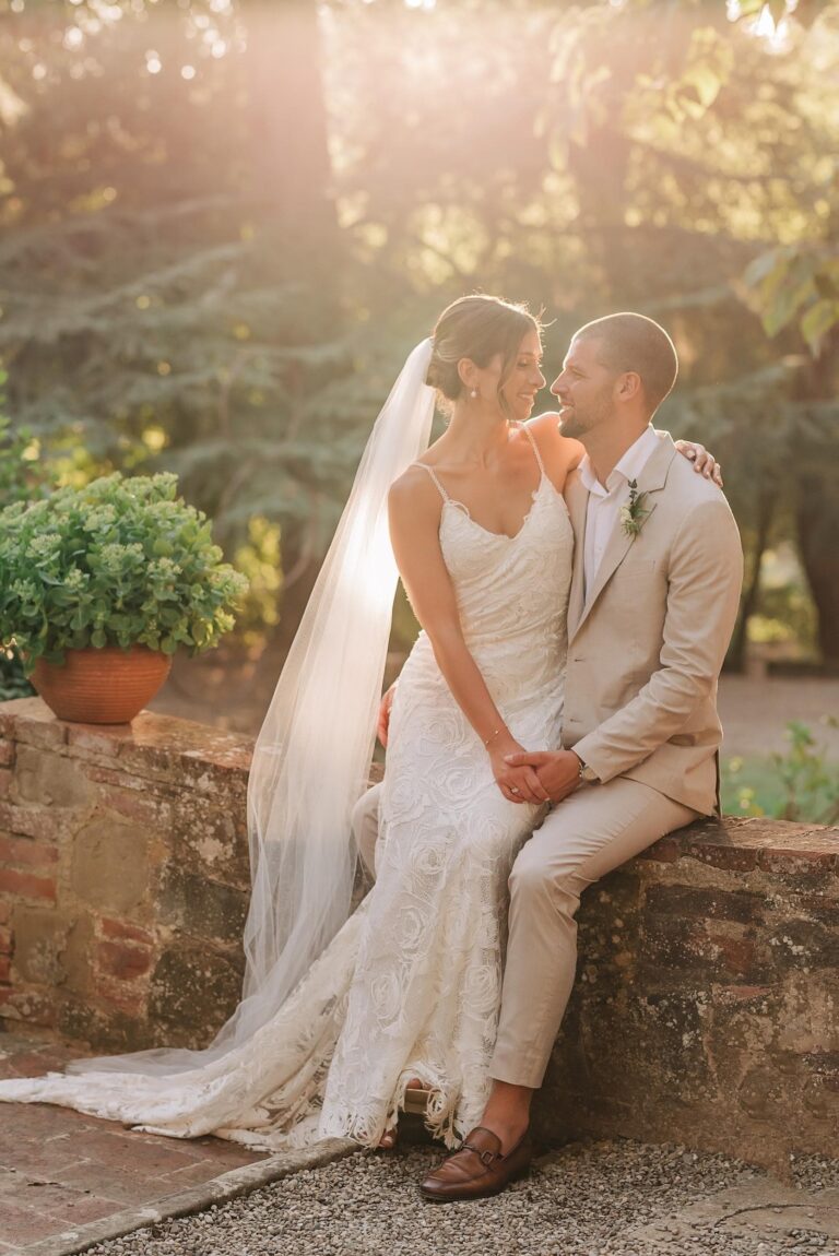 On a low stone wall at golden hour, Umbria Weddings and Events