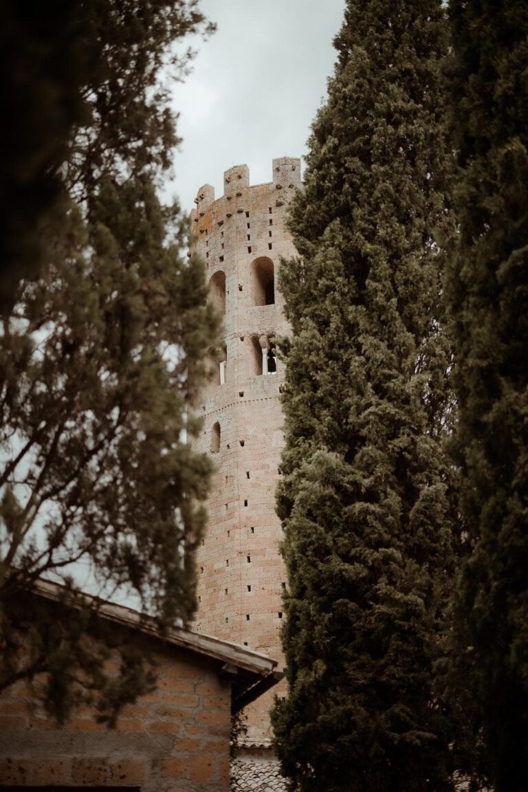 The medieval tower at La Badia di Orvieto, through the cypresses, Umbria Weddings and Events