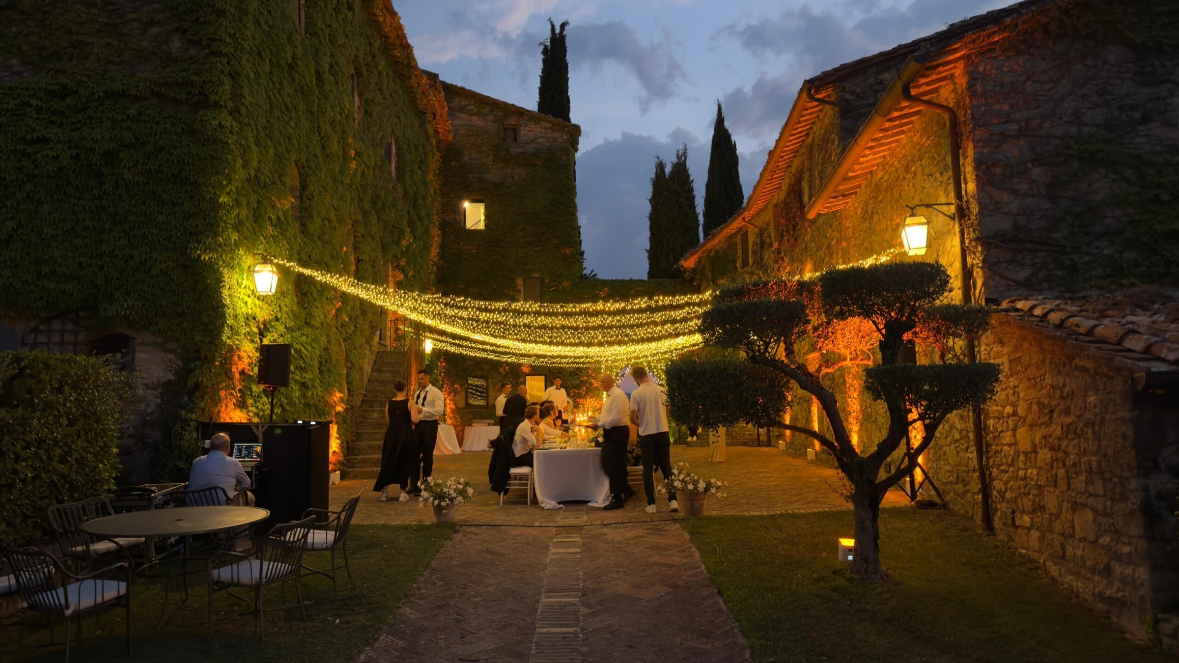 UMX Crew: Festoon lighting over a garden courtyard