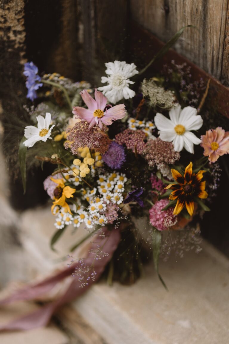 A wildflower bouquet resting on a timber stair, Upper House Hayfield