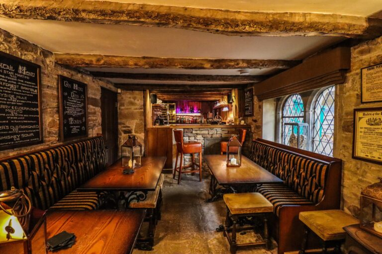 The Huntsman's Inn, the house pub, with beamed ceiling, booth seating and the bar, Upper House Hayfield