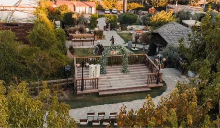 Aerial view of the garden with a wooden stage and a ceremony arch, Urla Sahne