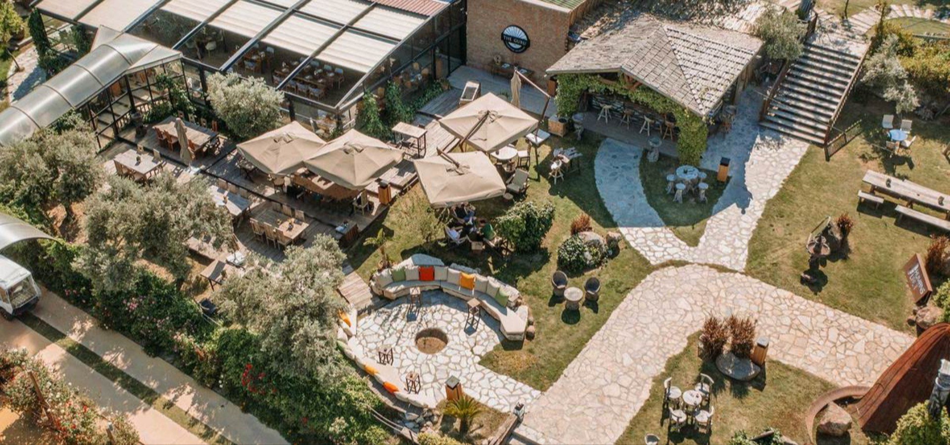 Aerial view of The Guru and its garden, with the stone paths and fire pit, Urla Sahne