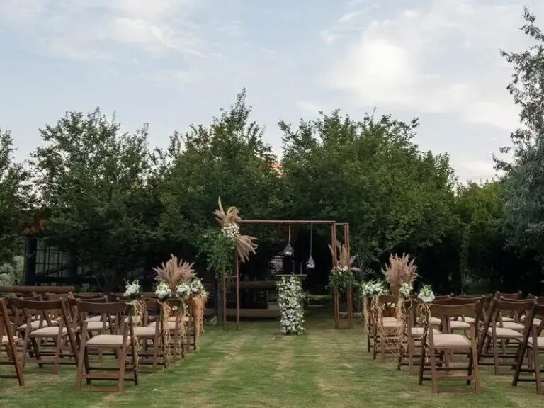 Wooden chairs on the lawn in front of a ceremony arbour, Urla Sahne
