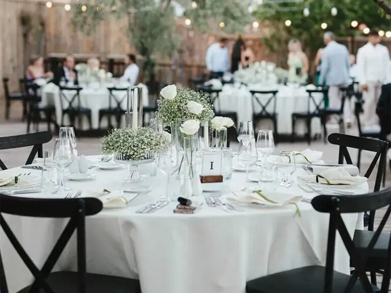 Round tables laid under string lights, Urla Sahne