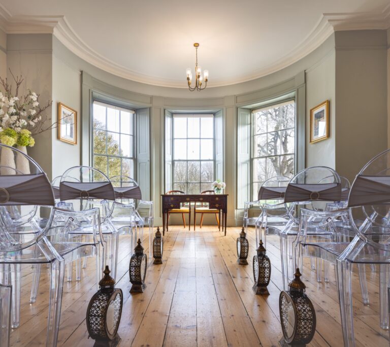 The Morning Room aisle, lanterns lining the boards, the bay window beyond, Valentines Mansion & Gardens