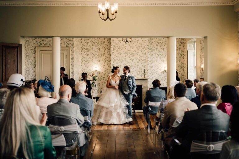 A ceremony in progress with seated guests in the Morning Room, Valentines Mansion & Gardens