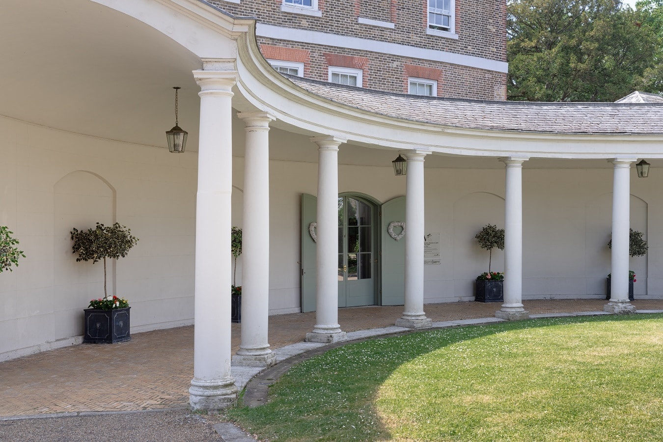 The colonnaded porte-cochere and its enclosed lawn, Valentines Mansion & Gardens