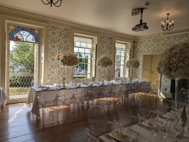 A long dressed table in the Drawing Room beneath the stained glass, Valentines Mansion & Gardens