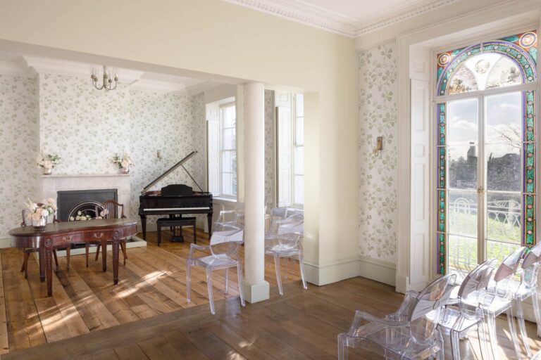 The Drawing Room with grand piano and ghost chairs, doors to the Regency Parlour, Valentines Mansion & Gardens