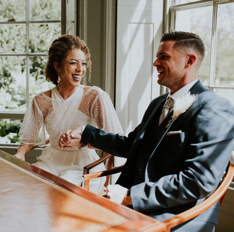 The couple laughing during the signing, Valentines Mansion & Gardens