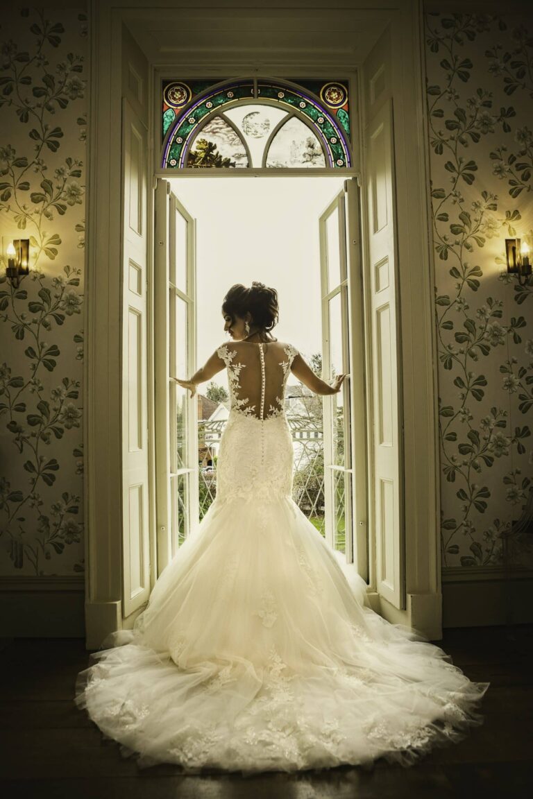 The bride framed in a doorway beneath the fanlight, Valentines Mansion & Gardens