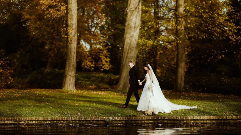 The couple walking the bank of the Long Water in autumn, Valentines Mansion & Gardens