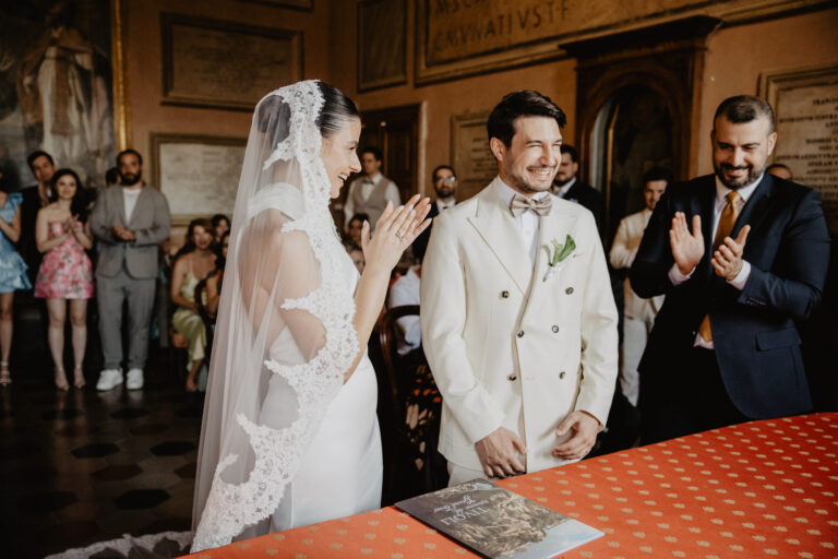 Rome ceremony with the bride in a long veil and guests applauding, Vera Weddings