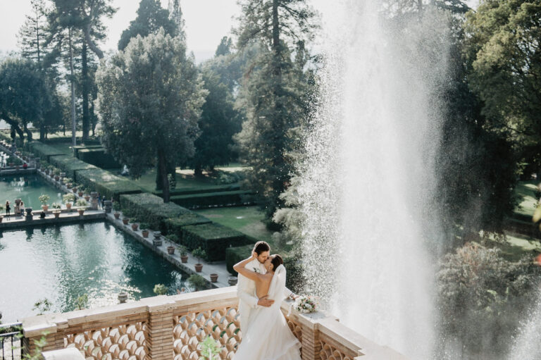 Couple on a garden terrace beside a tall fountain in Rome, Vera Weddings