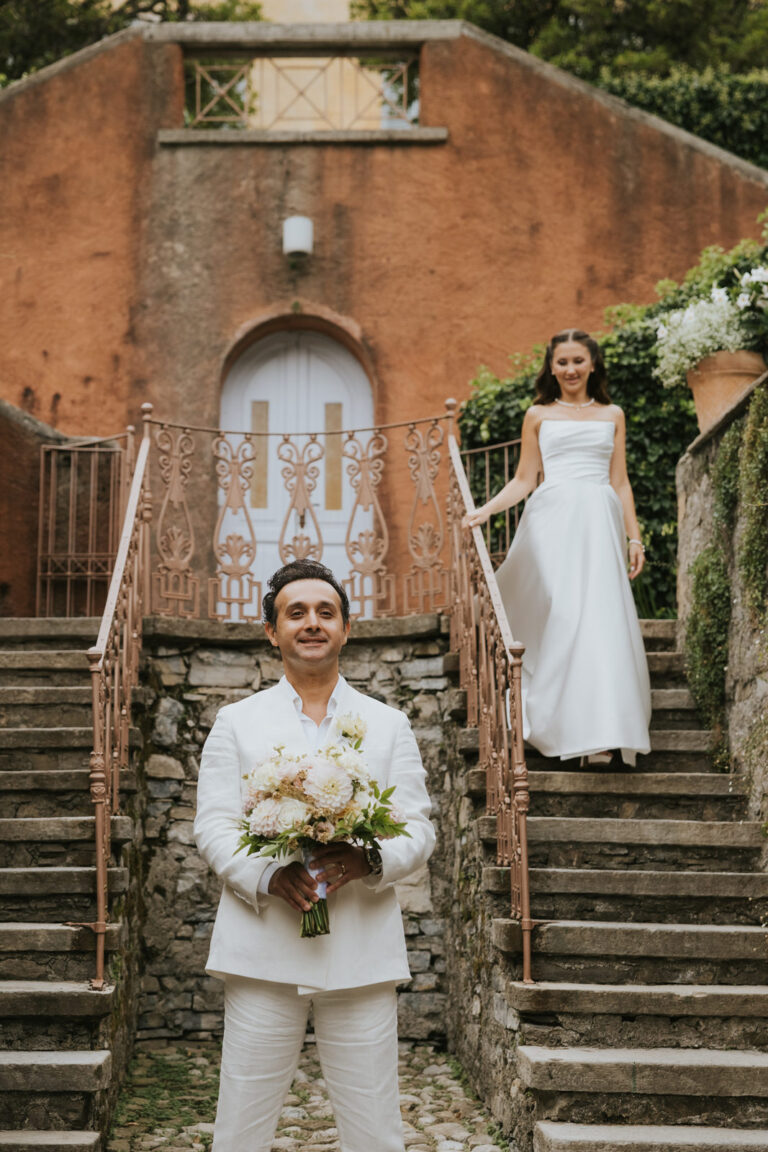 Groom and bride on a terracotta staircase at a Lake Como villa, Vera Weddings