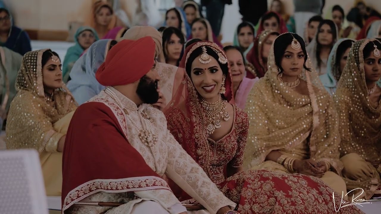 Bride and groom seated among guests at a Sikh ceremony, Gurdwara Sri Guru Singh Sabha, Southall, Vic Rivero Films