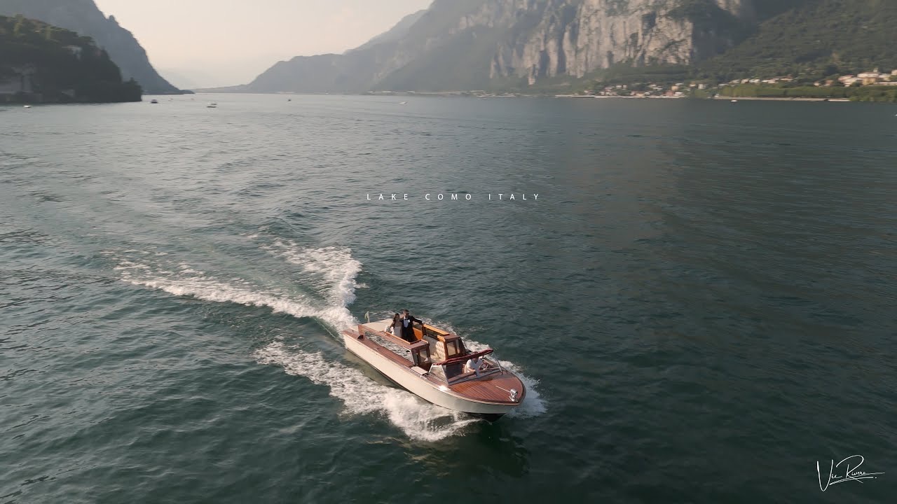 A wooden motor boat crossing Lake Como, Italy, frame from the Lake Como film, Vic Rivero Films