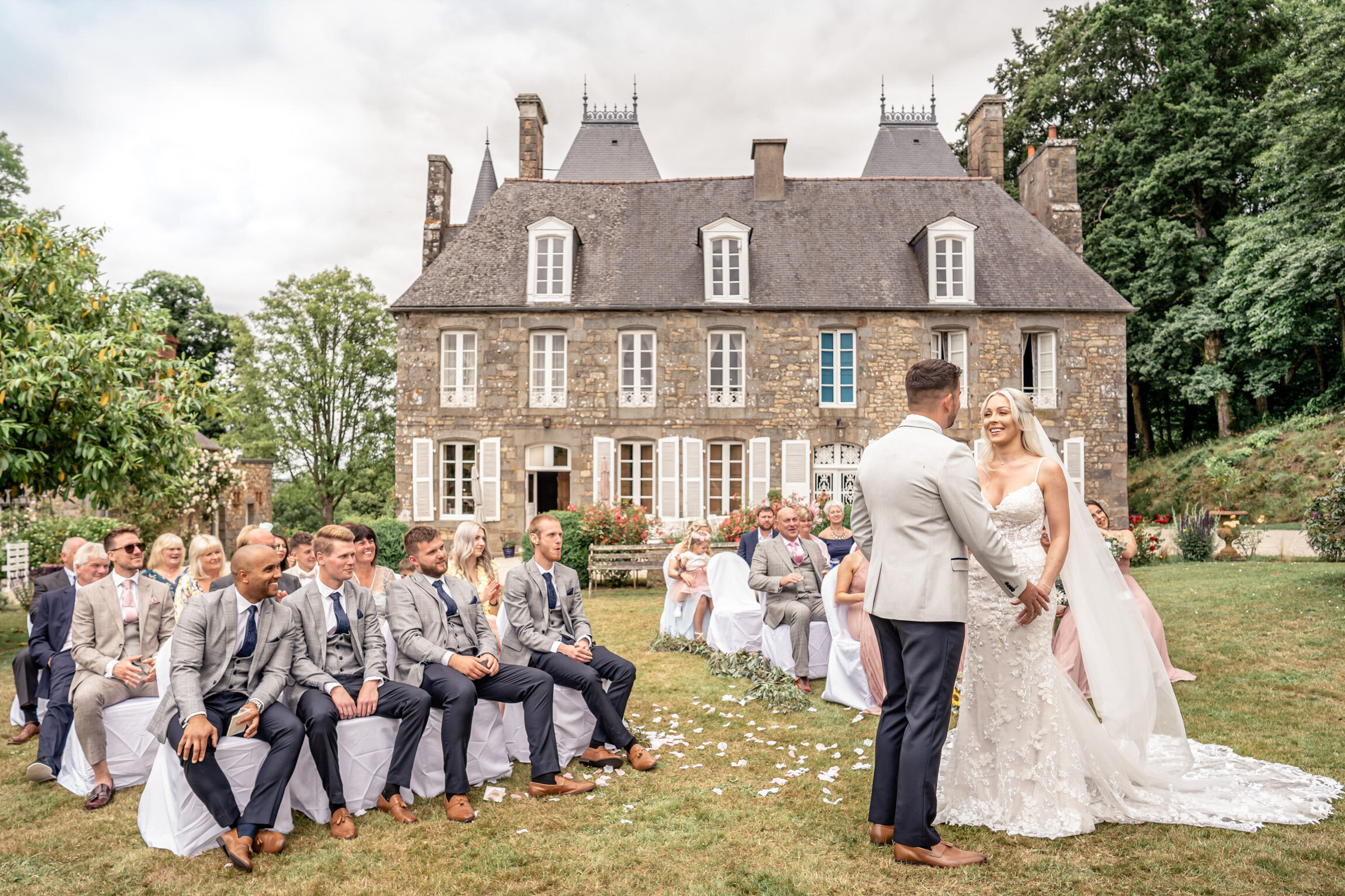 An outdoor ceremony on the lawn in front of the chateau, Chateau du Grand Val, Brittany, France, Victoria Amrose Photography