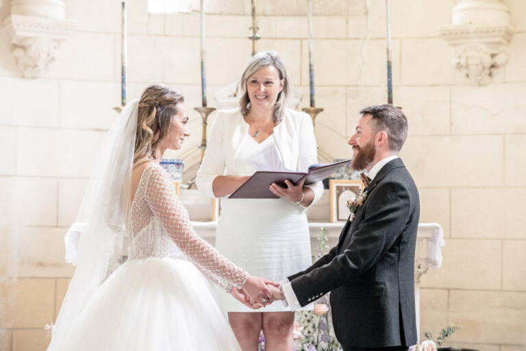 Holding hands for the vows in the estate chapel at Chateau de Bouthonvilliers, France, Victoria Amrose Photography