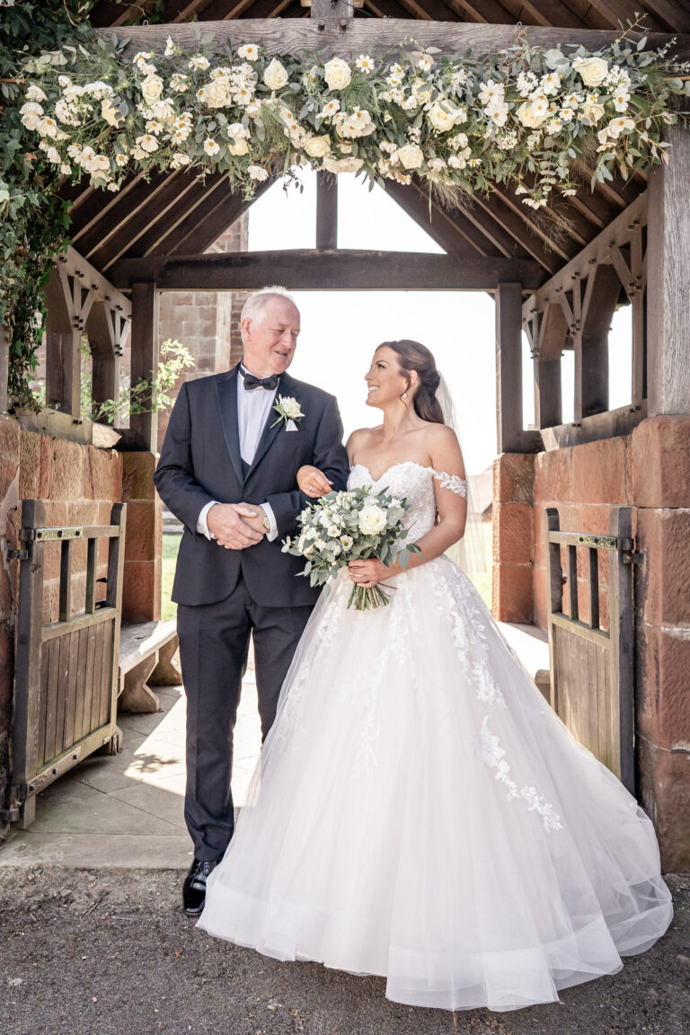 A bride and her father arriving at the church lychgate, for a Tyn Dwr Hall wedding, Wales, Victoria Amrose Photography