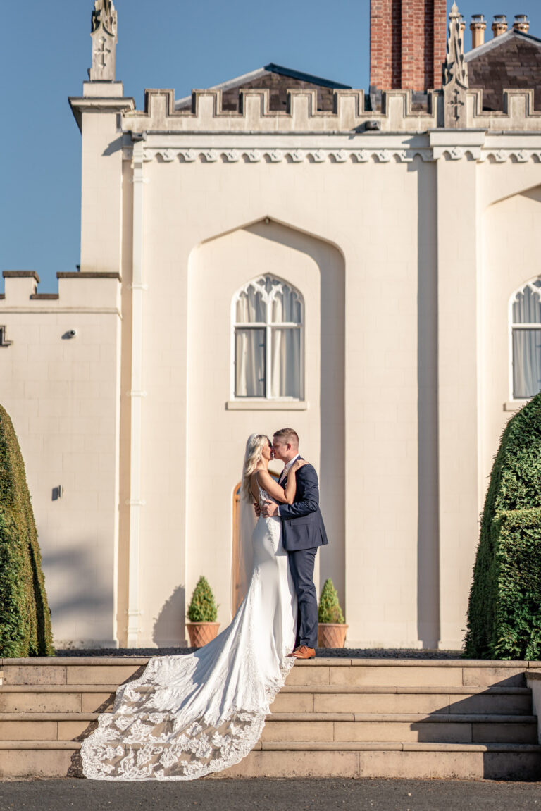 Bride and groom on the steps of Combermere Abbey, Shropshire, Victoria Amrose Photography