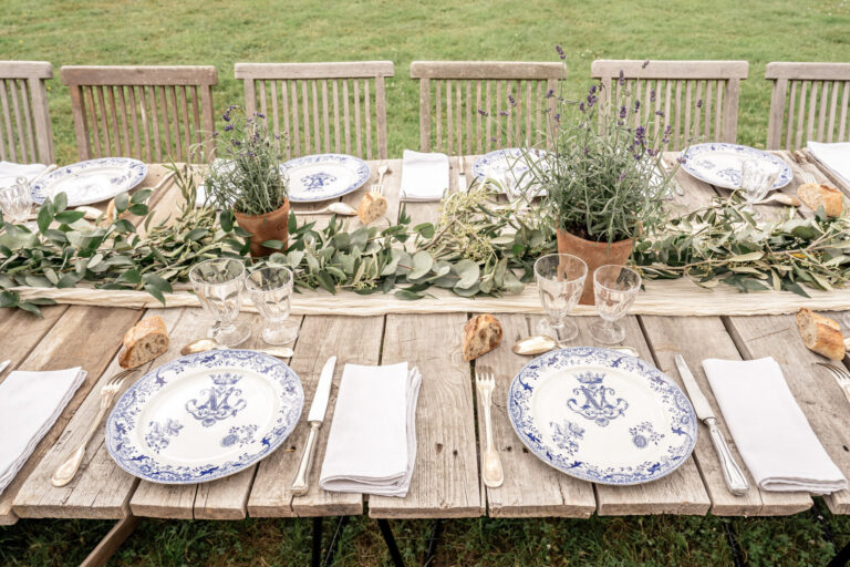 A long table set with blue-and-white plates and lavender, Chateau de Bouthonvilliers, France, Victoria Amrose Photography