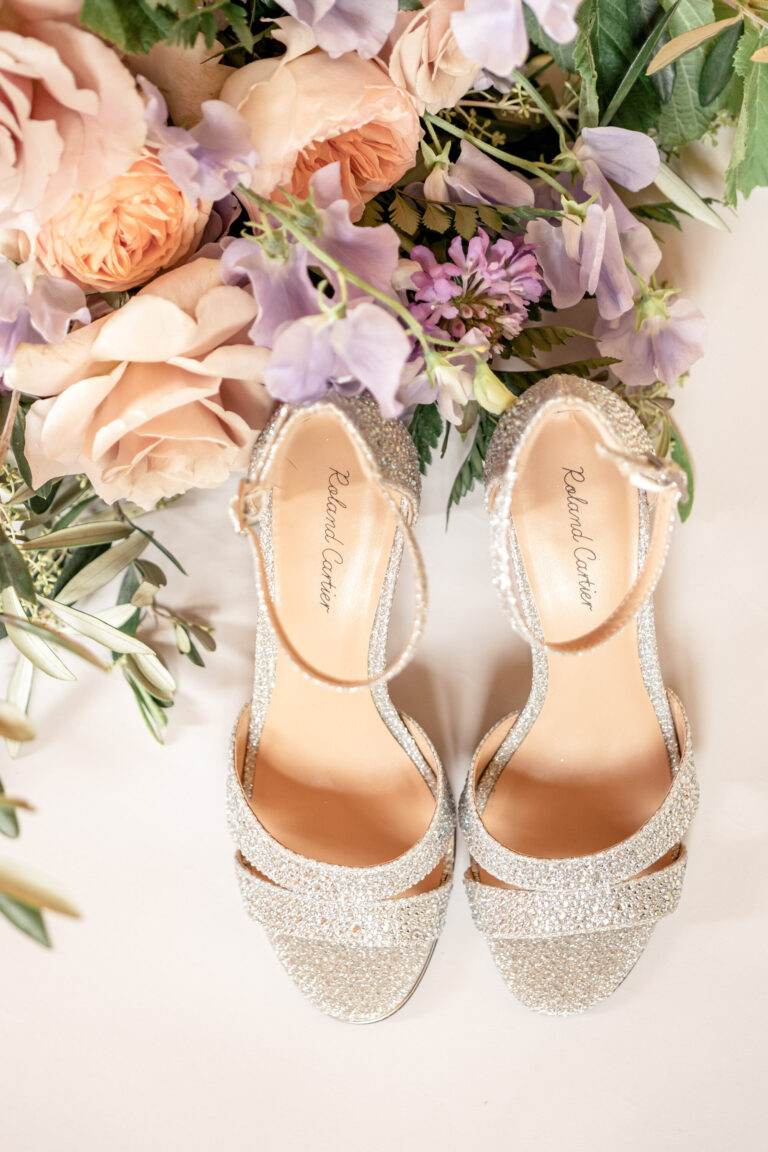 Bridal shoes laid with peach and lilac flowers, Chateau de Bouthonvilliers, France, Victoria Amrose Photography