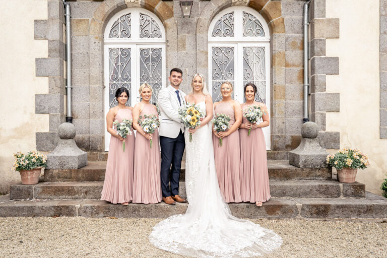 The bride with her bridesmaids on the chateau steps, Chateau du Grand Val, Brittany, France, Victoria Amrose Photography