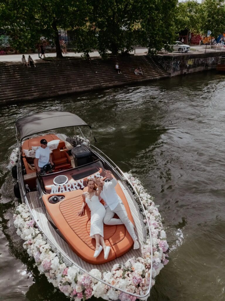 Proposal by boat on a vienna canal, the boat wreathed in white flowers, Vienna Picnics