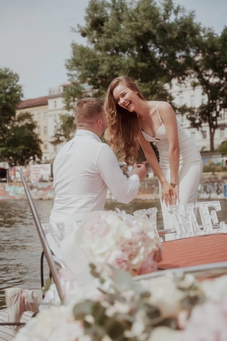 A proposal on the water with a marry me sign and white roses, Vienna Picnics