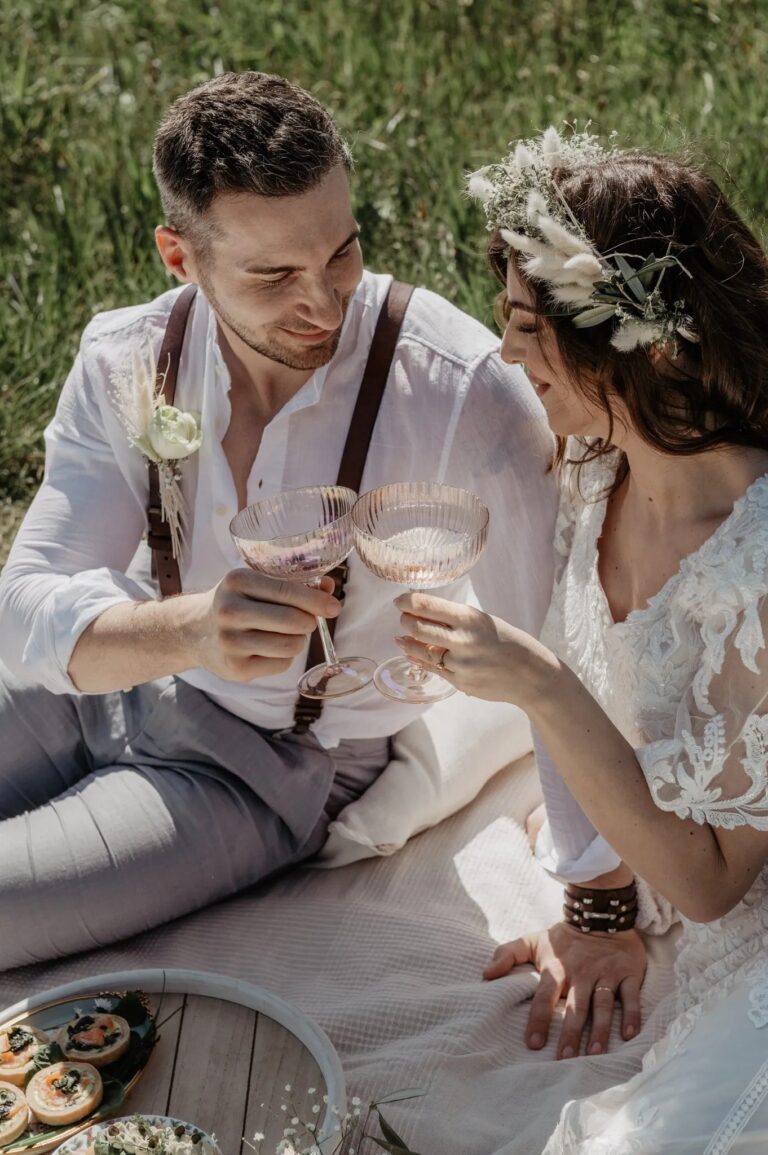 Couple toasting with coupes at a boho elopement picnic, Vienna Picnics