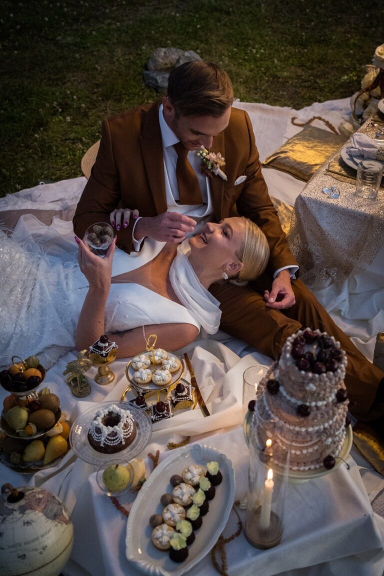 Couple sharing a picnic with cakes and fruit at dusk, Vienna Picnics