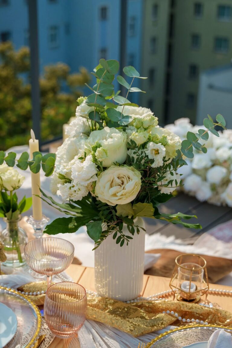 White rose and eucalyptus arrangement on a picnic table, Vienna Picnics