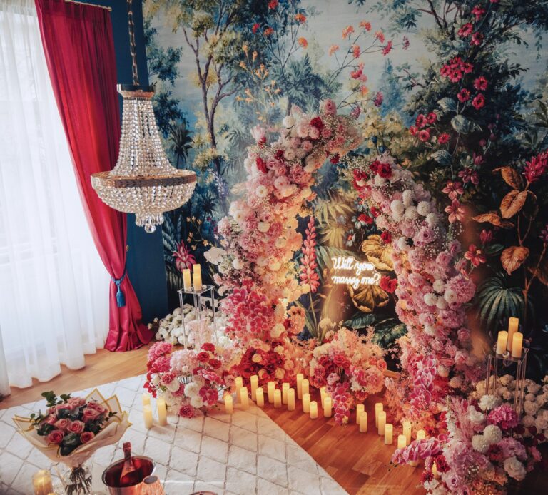 Indoor proposal set-up with a floral wall, chandelier and candles, Vienna Picnics