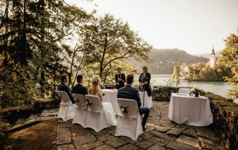 A small ceremony on the lakeside terrace, with Bled Island in the distance, Vila Bled