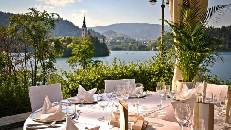 A table laid on the terrace with a view of Bled Island, Vila Bled