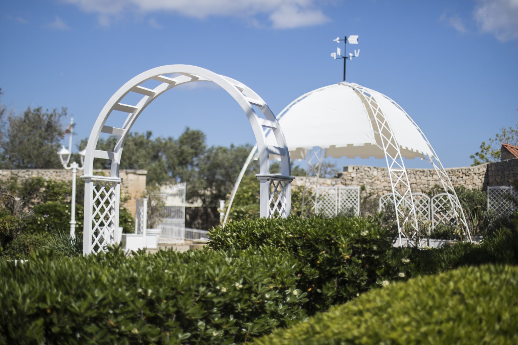 A white garden arch and dome in the grounds, Villa Arrigo
