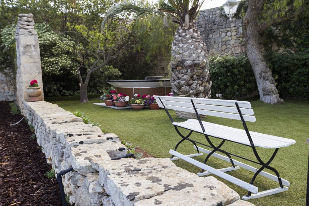A garden bench against the old stone wall, Villa Arrigo