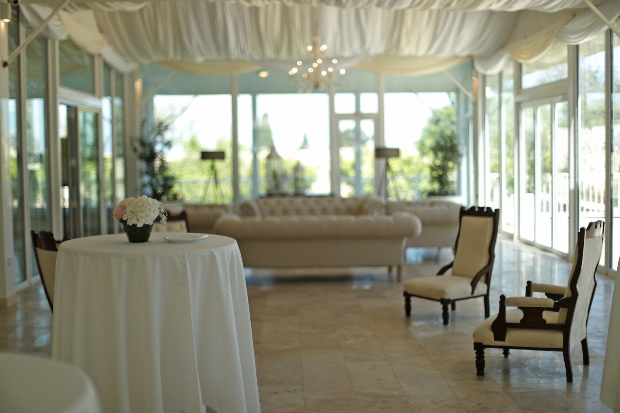 The glass-walled marquee set with a lounge area, Villa Arrigo