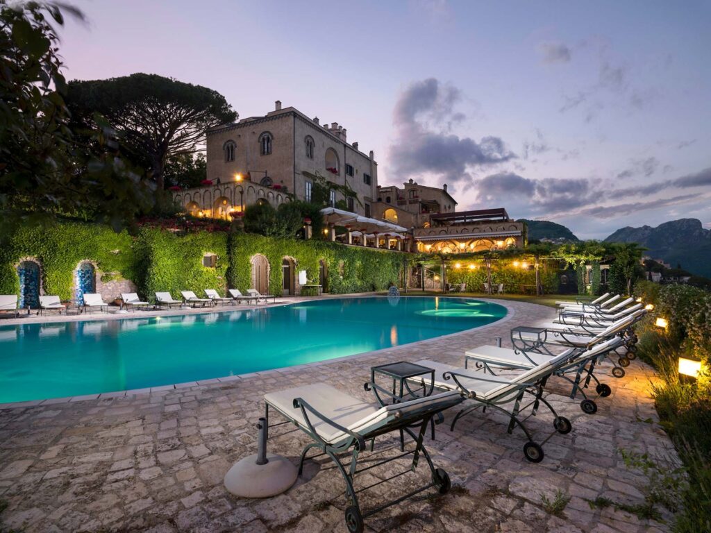 Swimming pool and loungers in front of the villa at dusk, Villa Cimbrone