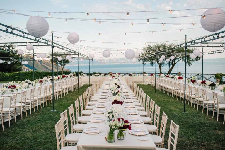 Long tables on the lawn under strings of lanterns, facing the sea, Villa Cimbrone